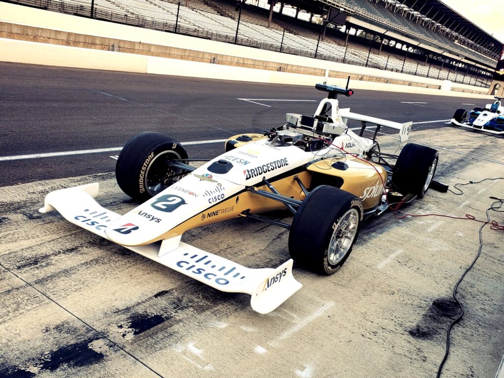 Black and Gold Autonomous Racing car on pit lane at Indianapolis Motor Speedway