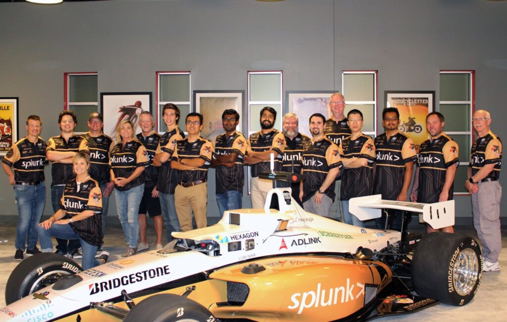 The full Black and Gold Autonomous Racing team with the car