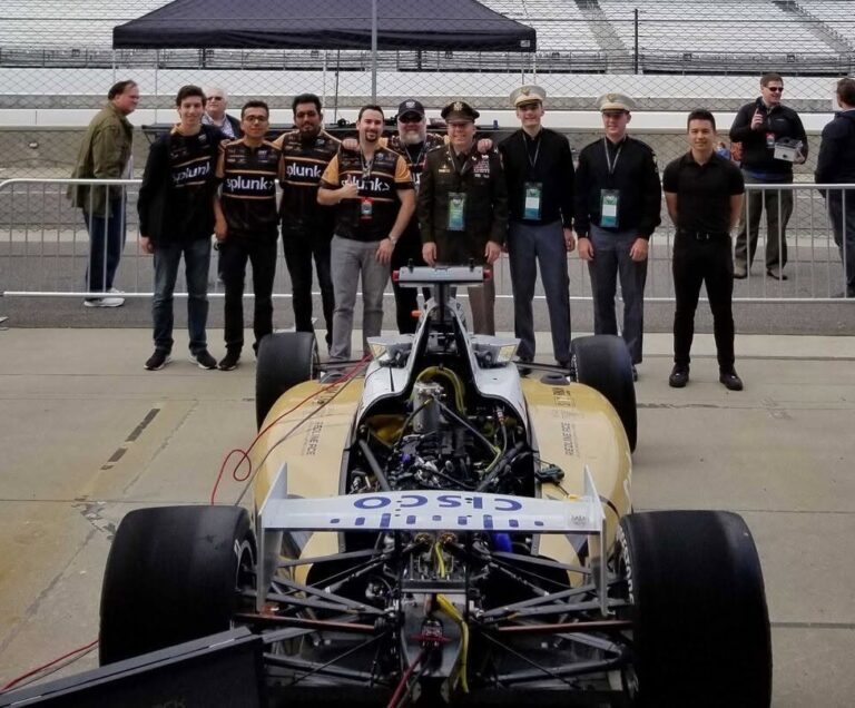 West Point and Purdue team members with the car at Indianapolis Motor Speedway